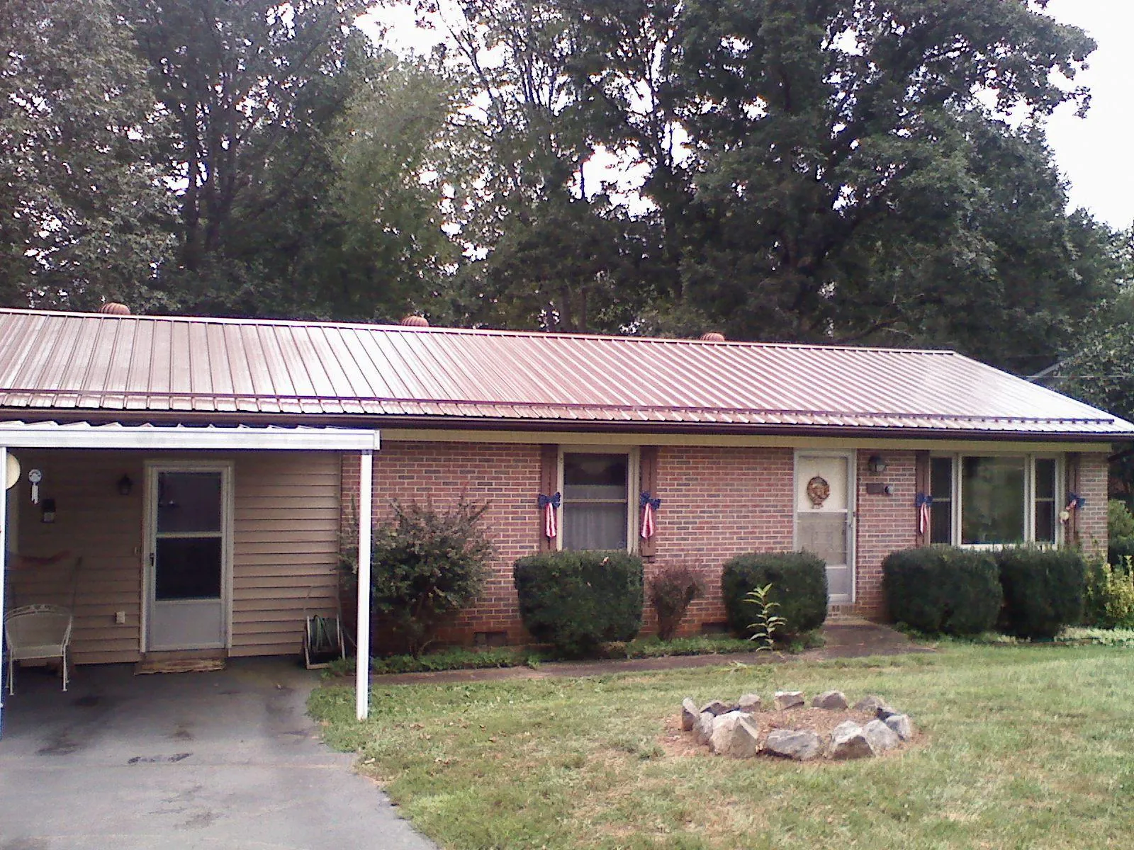 Bronze metal roof and carport on a brick ranch home — Roof Repair work by our crew in Seekonk