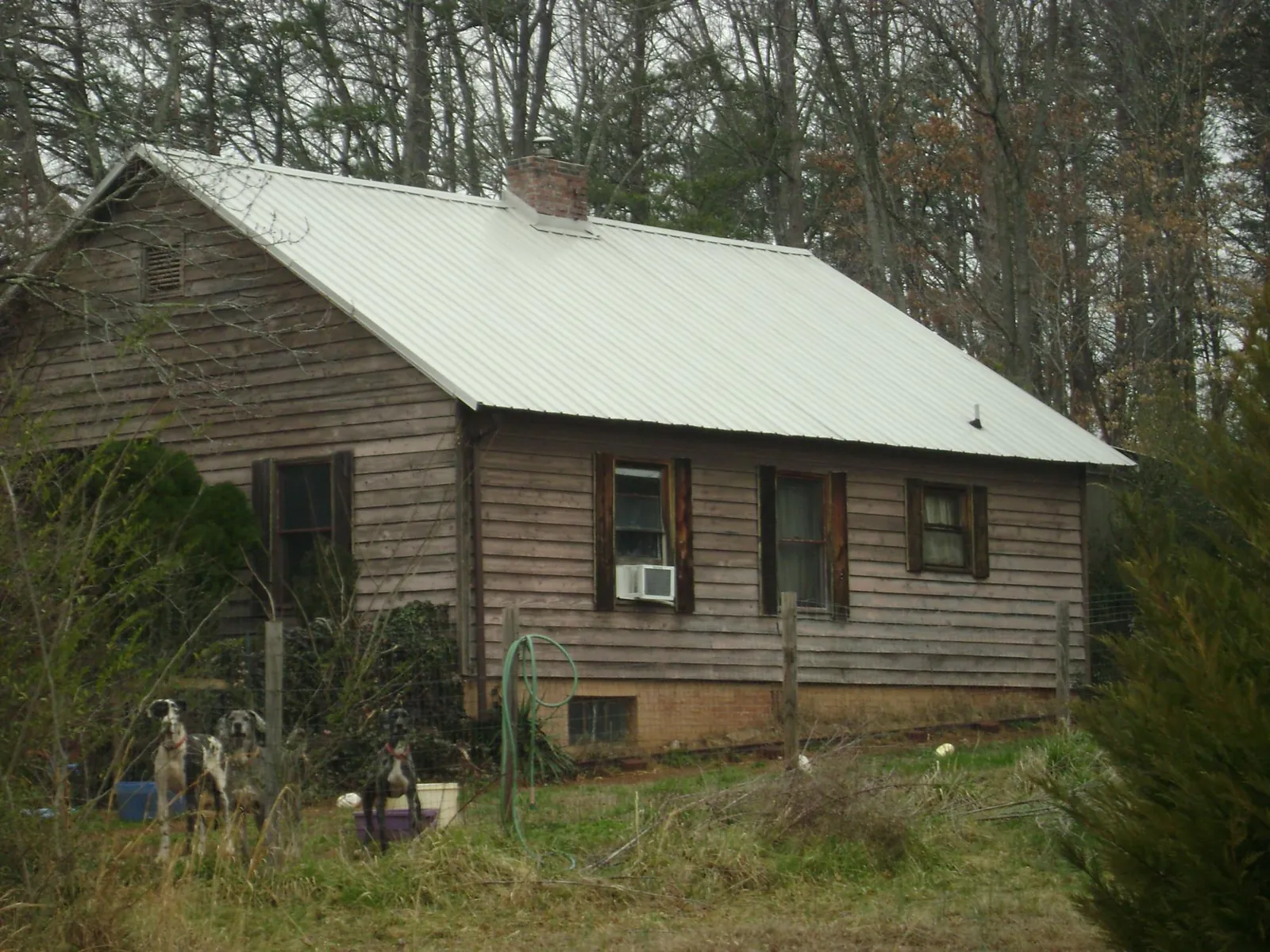 White metal roof on an old wood sided farmhouse, from a Metal Roof Installation job in Seekonk